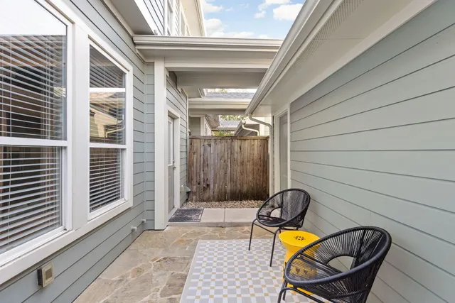 a view of a two chairs in the balcony