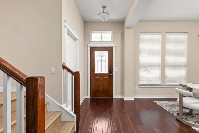 an entryway with wooden floor and a window