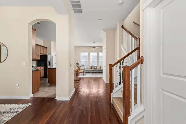 a view of entryway and hall with wooden floor