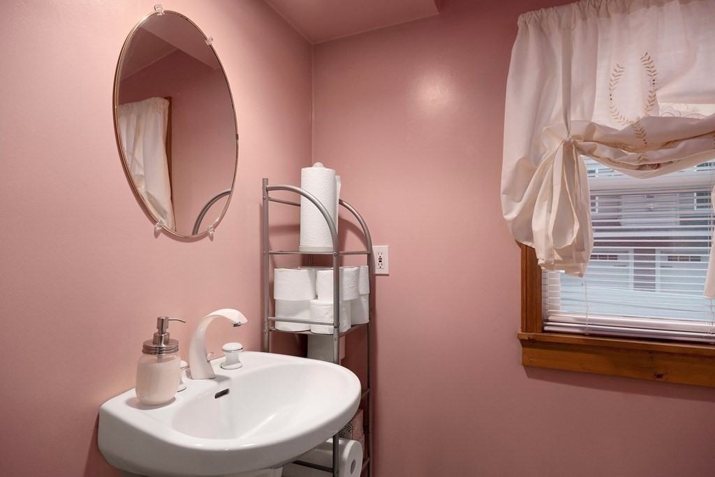 102 Orange Street Reading, MA 01867 - Photo 9 of 23 a bathroom with a sink and a mirror