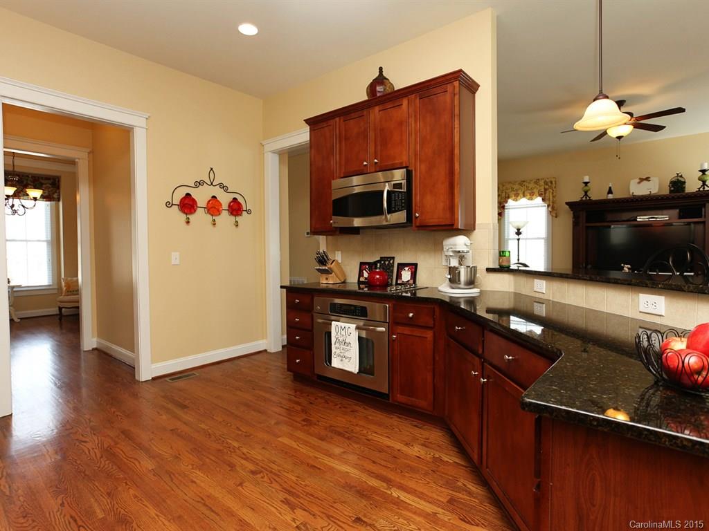 742 Revival Row Fort Mill, SC 29708 - Photo 11 of 24 a kitchen with granite countertop stainless steel appliances a stove microwave and cabinets