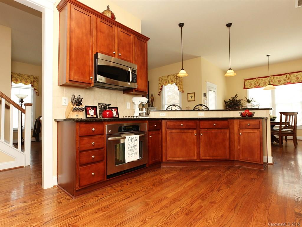 742 Revival Row Fort Mill, SC 29708 - Photo 13 of 24 a kitchen with stainless steel appliances granite countertop a stove a sink and a microwave
