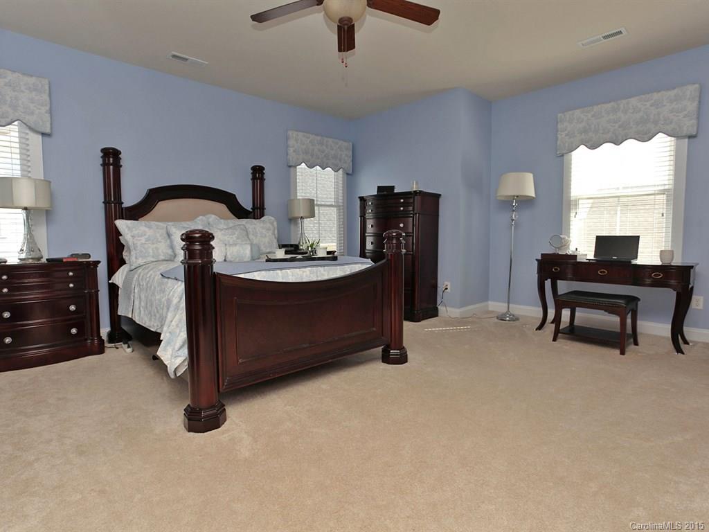 742 Revival Row Fort Mill, SC 29708 - Photo 16 of 24 a bedroom with bed and a chandelier