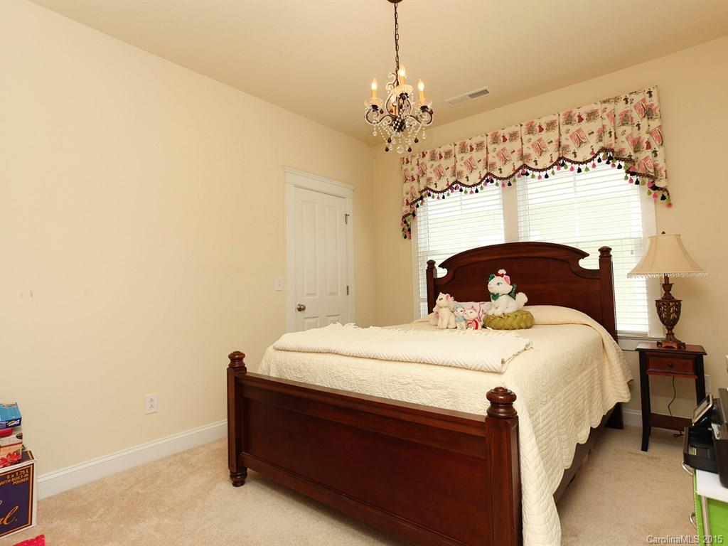 742 Revival Row Fort Mill, SC 29708 - Photo 20 of 24 a bedroom with a bed table and window