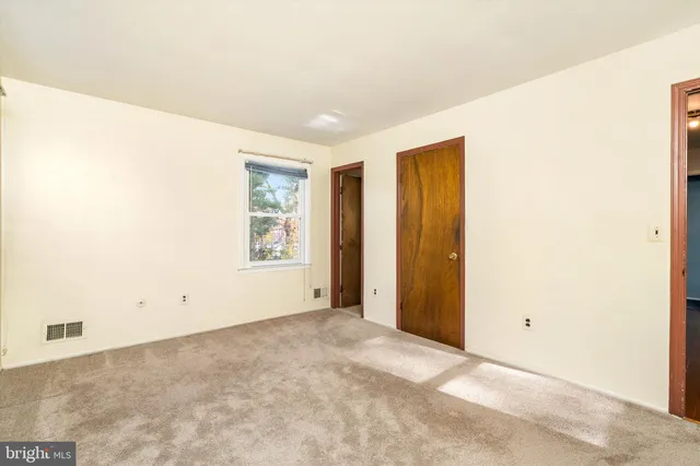 a bathroom with a granite countertop toilet sink and a mirror