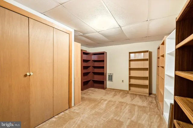 a row of white house with large trees