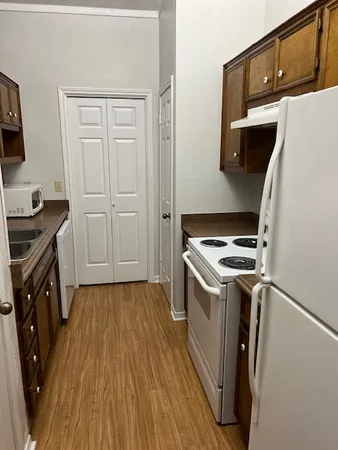 a kitchen with a sink a stove and refrigerator
