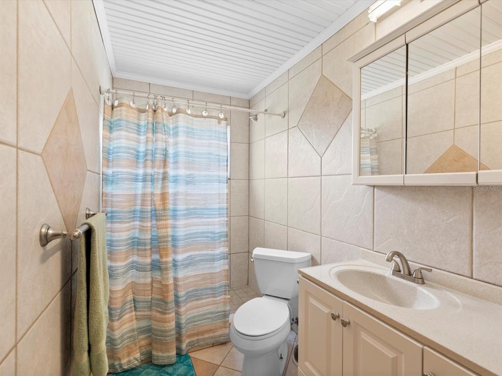 5904 Springrun Court Holiday, FL 34690 - Photo 35 of 53 a bathroom with a sink toilet and shower