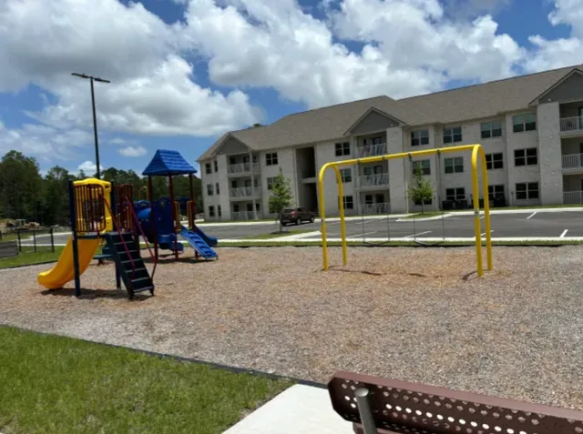 a view of a park with swings and slides