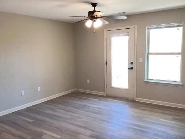 800 Winding Road Kingsland, GA 31548 - Photo 7 of 9 wooden floor in an empty room with a window
