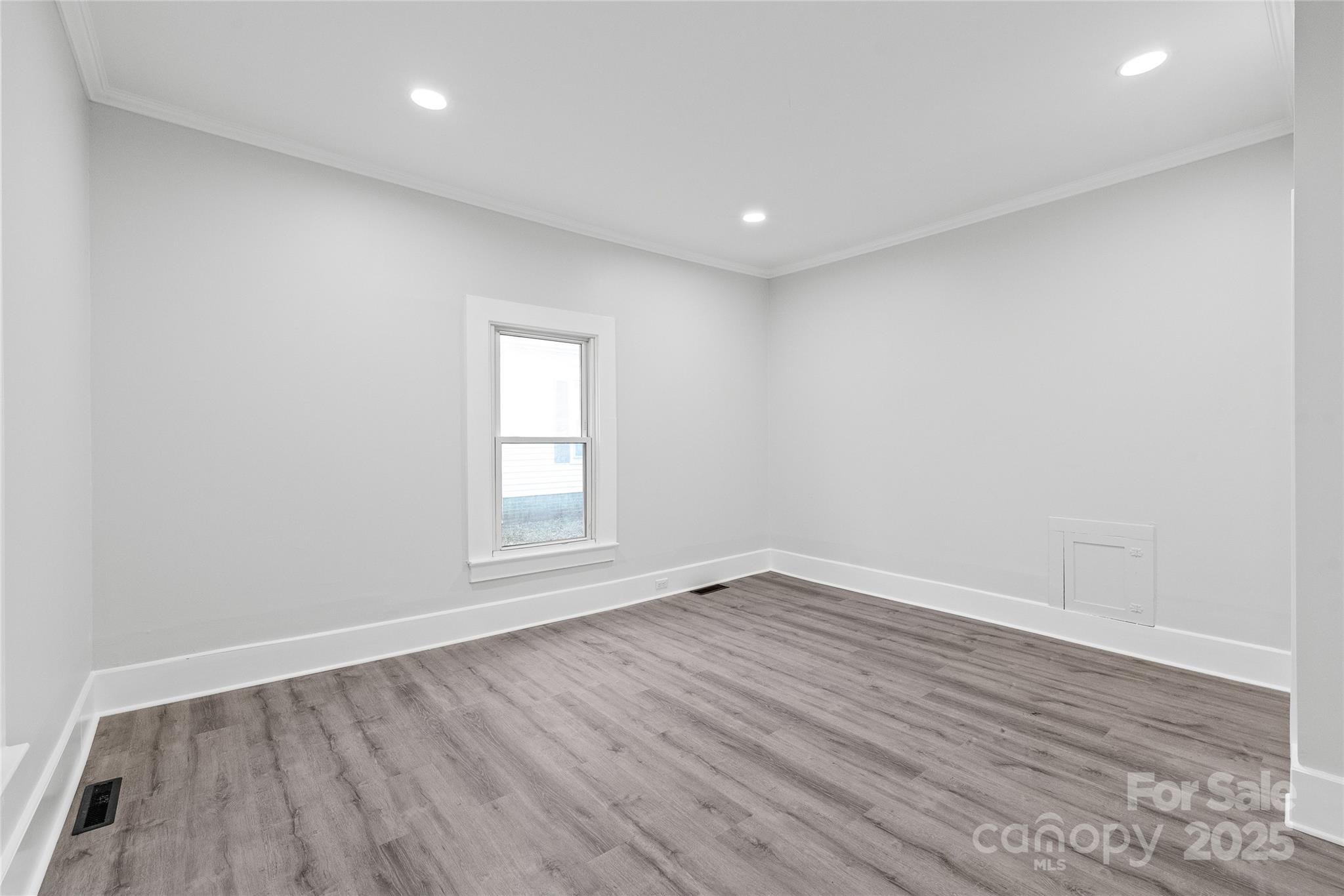 63 3rd Street Northwest Concord, NC 28027 - Photo 18 of 28 a view of empty room with wooden floor and fan