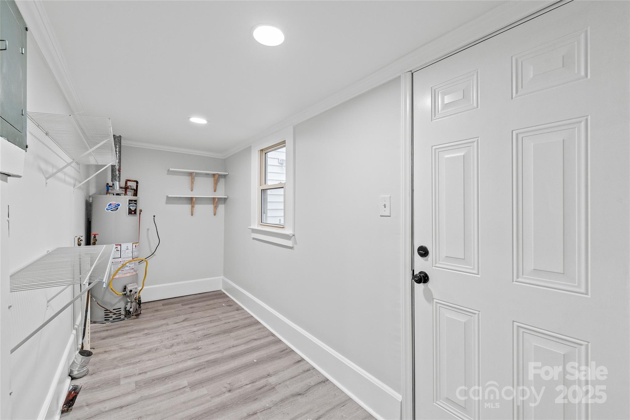63 3rd Street Northwest Concord, NC 28027 - Photo 22 of 28 a very nice looking room with a wooden floor and a window
