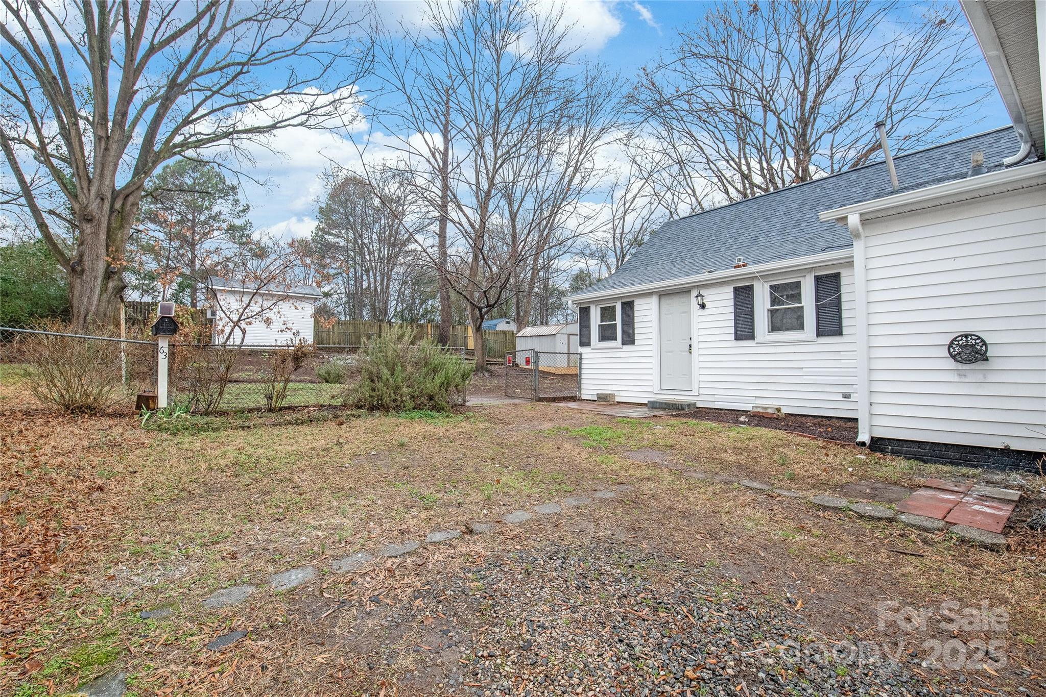 63 3rd Street Northwest Concord, NC 28027 - Photo 26 of 28 a view of a house with a yard