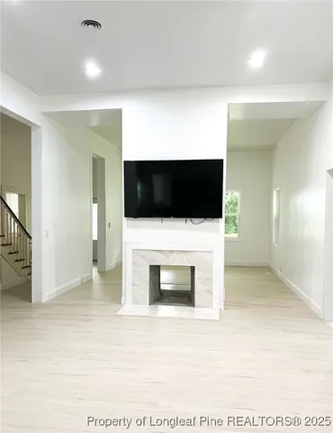 a living room with a flat screen tv and a fireplace