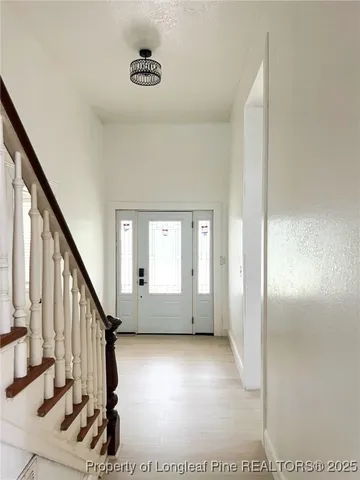 a view of an entryway with wooden floor