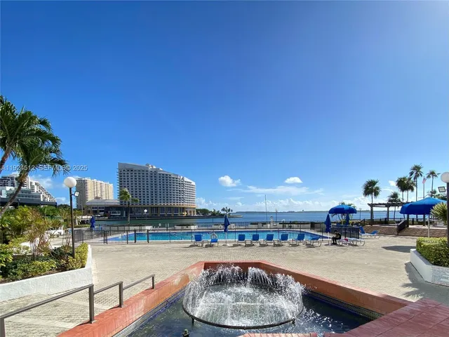 a dining room with furniture and a kitchen view