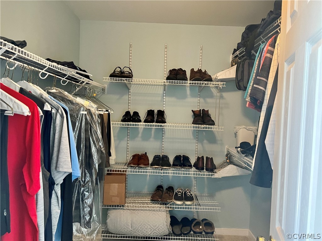 8428 Rowanty Road Carson, VA 23830 - Photo 11 of 22 a view of walk in closet with clothes and shoes