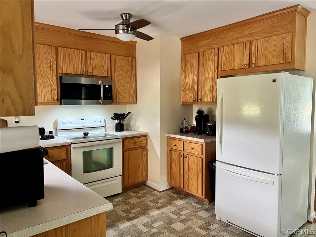 8428 Rowanty Road Carson, VA 23830 - Photo 8 of 22 a kitchen with granite countertop a refrigerator stove and sink