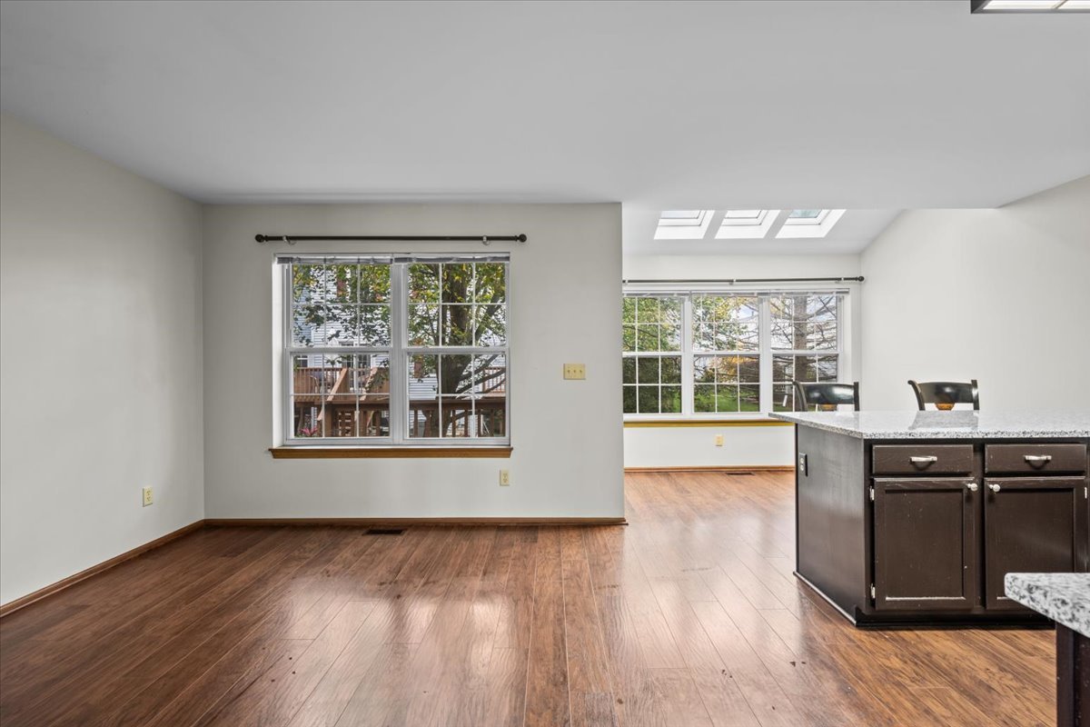 1215 Koster Court Geneva, IL 60134 - Photo 11 of 22 a view of an empty room with wooden floor and a window