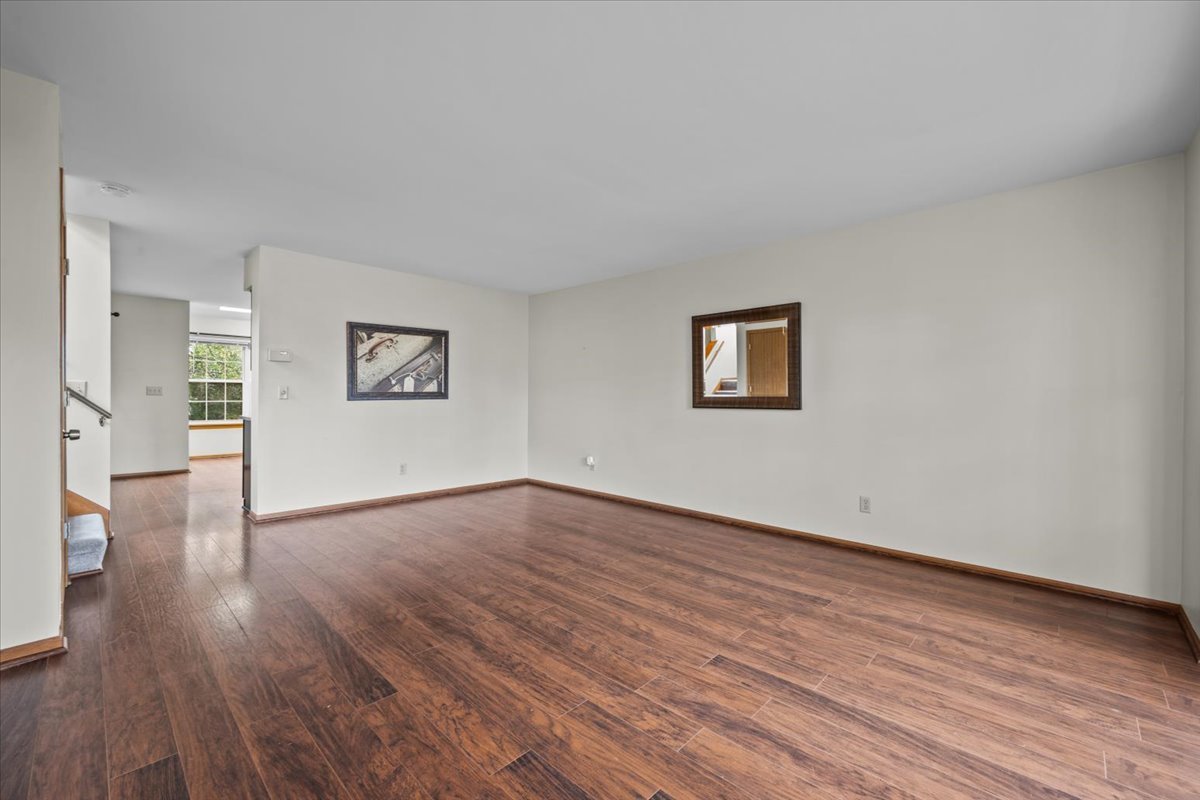 1215 Koster Court Geneva, IL 60134 - Photo 4 of 22 a view of an empty room with wooden floor and a window