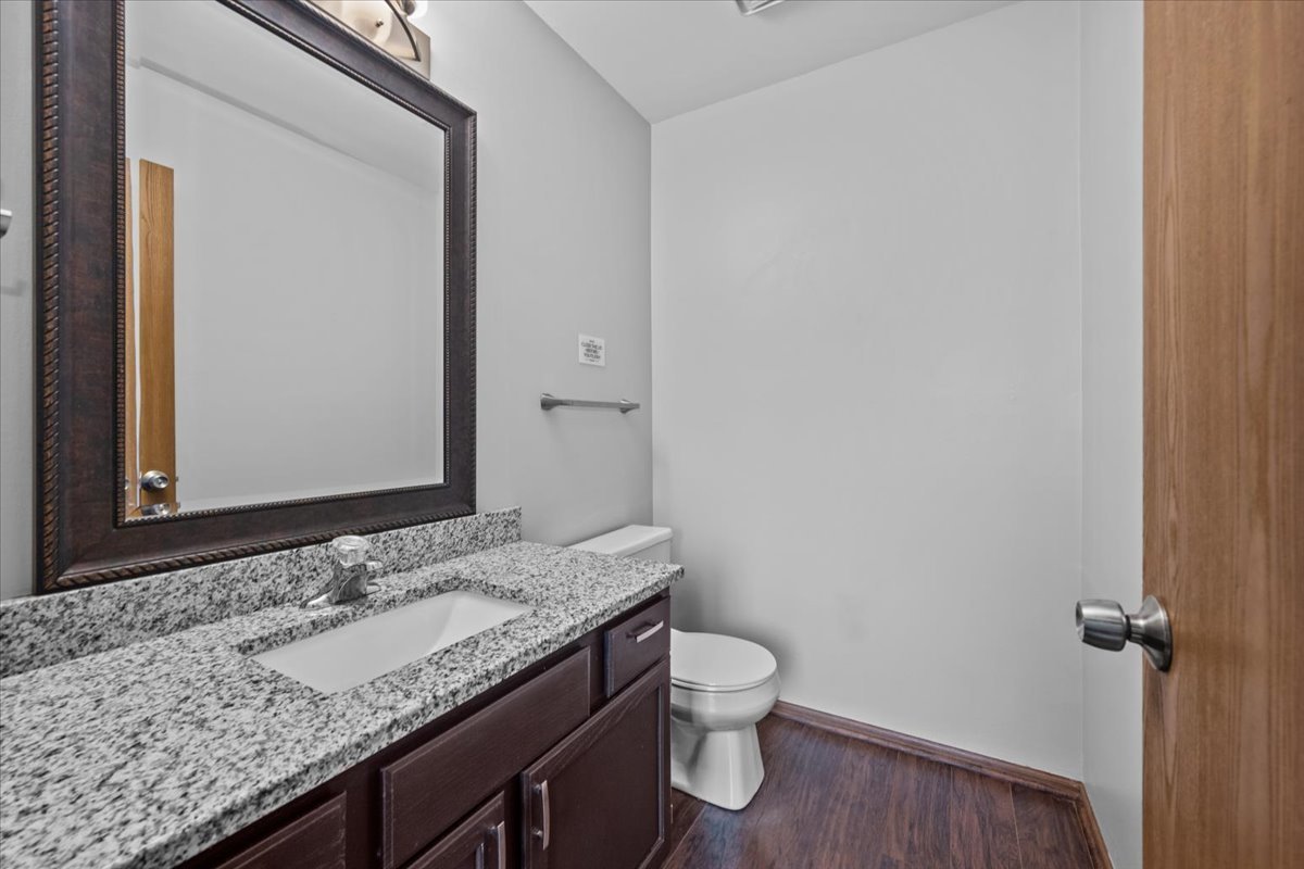 1215 Koster Court Geneva, IL 60134 - Photo 7 of 22 a bathroom with a granite countertop sink and a toilet