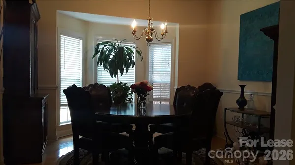 a view of a dining room with furniture and chandelier