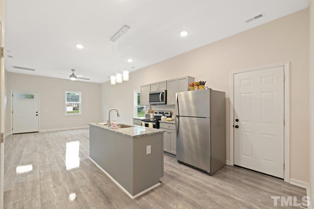 154 Summit Street Roxboro, NC 27573 - Photo 13 of 19 a kitchen with stainless steel appliances granite countertop a refrigerator and a stove