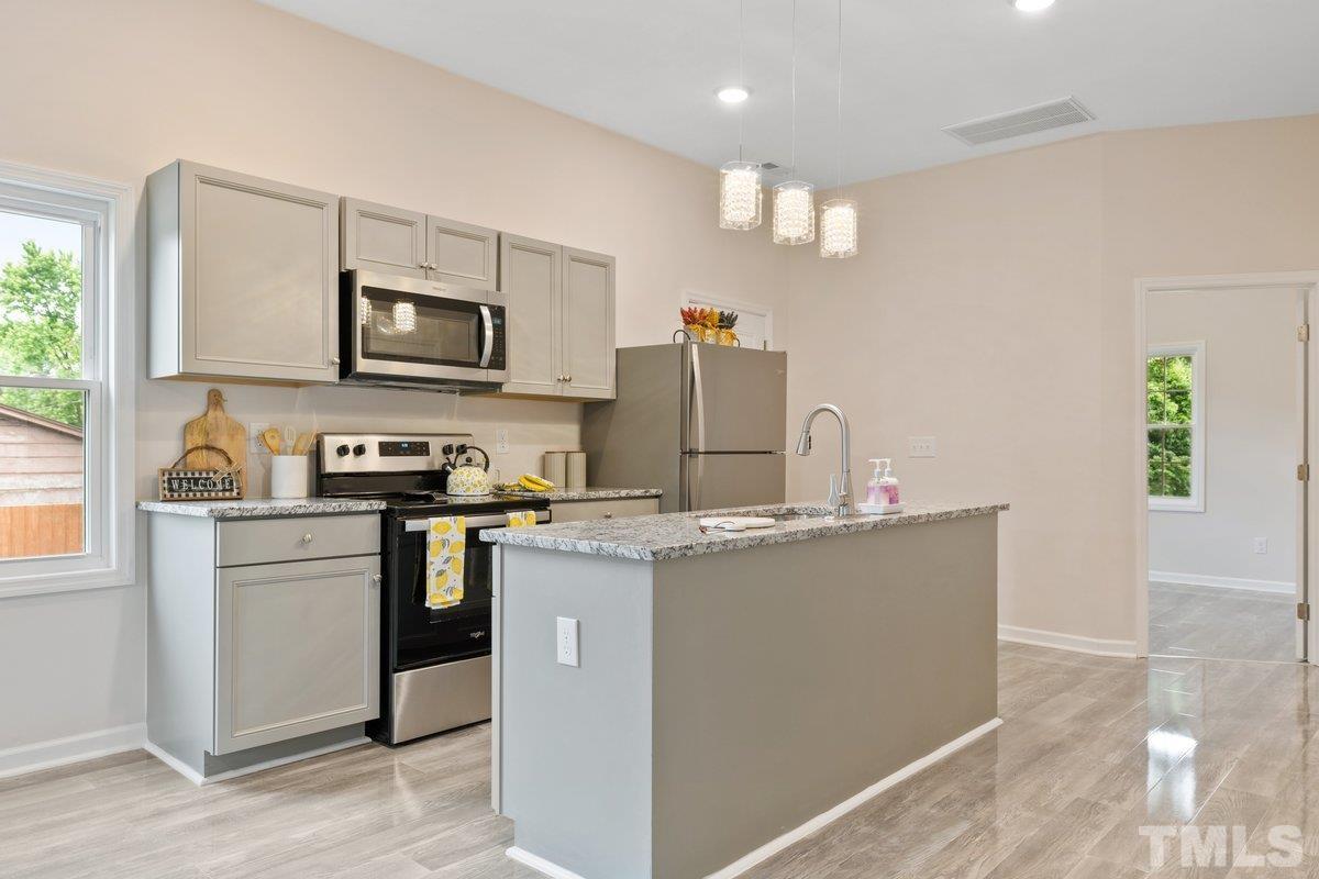 154 Summit Street Roxboro, NC 27573 - Photo 14 of 19 a kitchen with stainless steel appliances a stove refrigerator sink and microwave