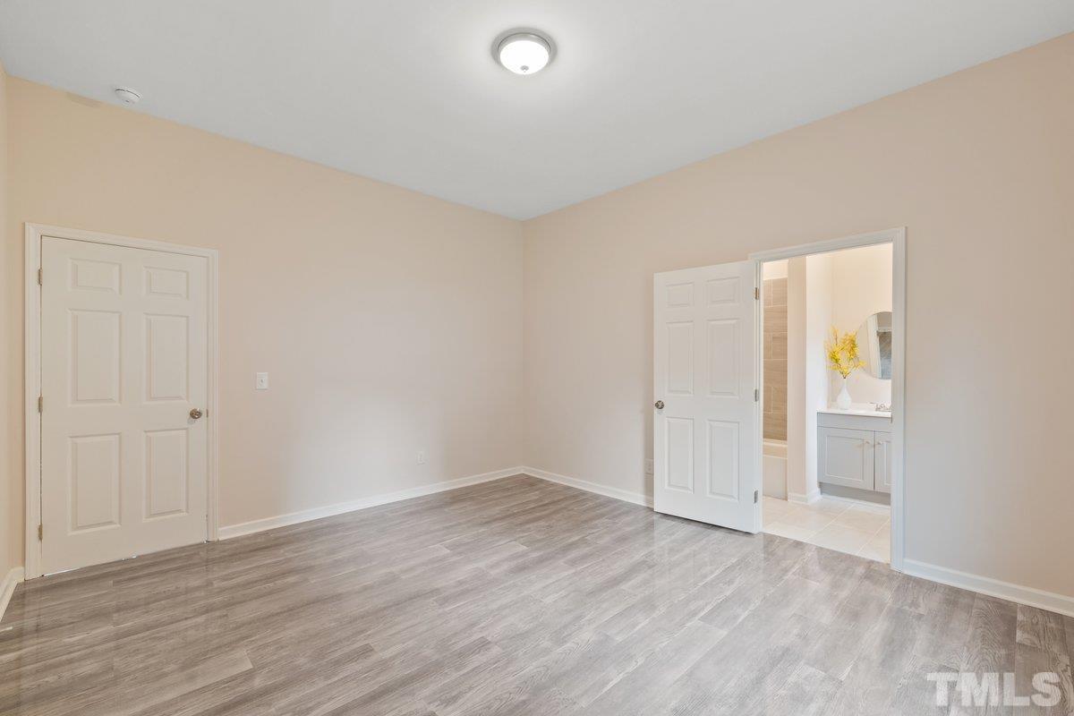 154 Summit Street Roxboro, NC 27573 - Photo 3 of 19 a view of an empty room with wooden floor and closet