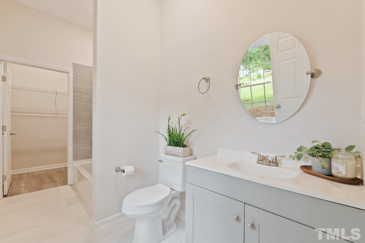154 Summit Street Roxboro, NC 27573 - Photo 5 of 19 a bathroom with a sink a mirror and a toilet