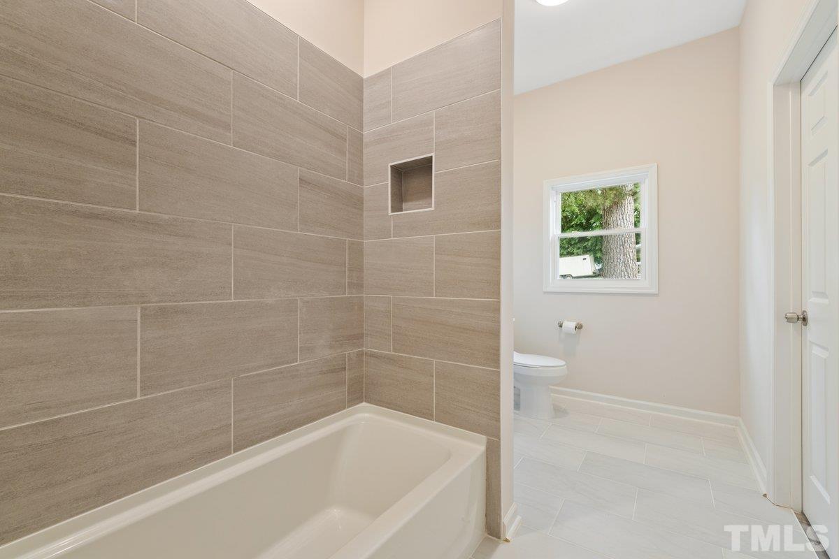 154 Summit Street Roxboro, NC 27573 - Photo 8 of 19 a bathroom with a bathtub