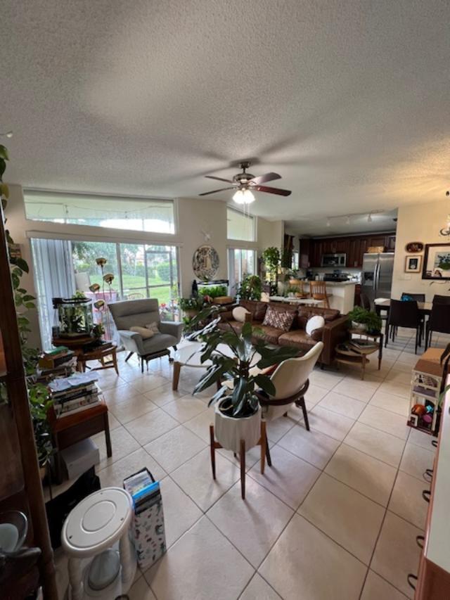 11750 Timbers Way Boca Raton, FL 33428 - Photo 7 of 25 a living room with lots of furniture a rug a flat screen tv and a window