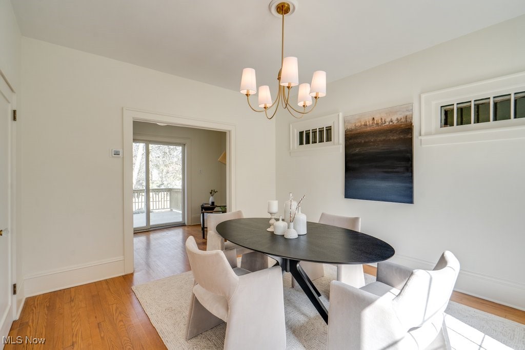 199 Edgerton Road Akron, OH 44303 - Photo 14 of 49 Dining room with a notable chandelier, baseboards, and light wood-type flooring