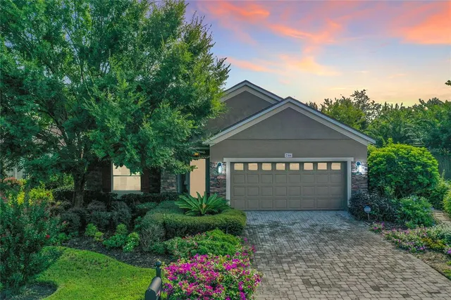 a view of a house with a yard and garden