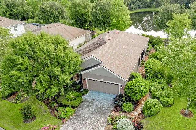 an aerial view of a house with a garden and swimming pool