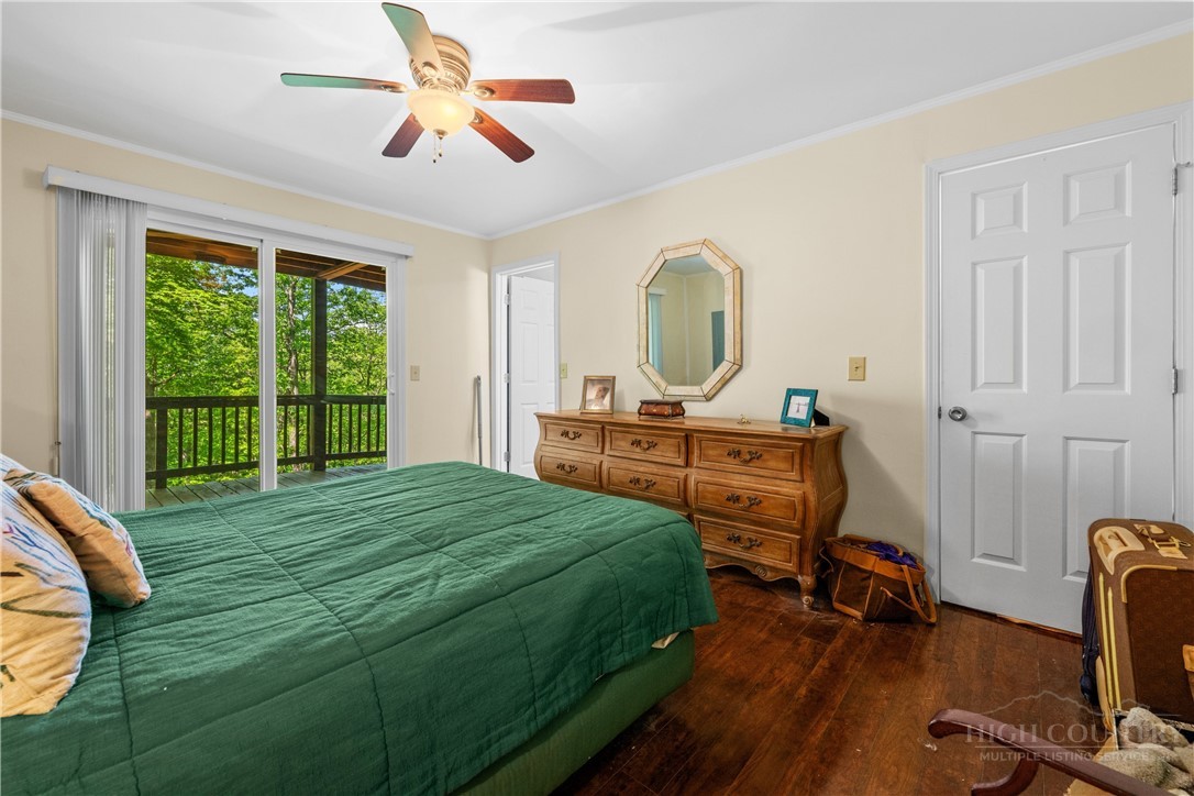 467 Horseshoe Ridge Road East Deep Gap, NC 28618 - Photo 25 of 46 a bedroom with a bed and a chandelier