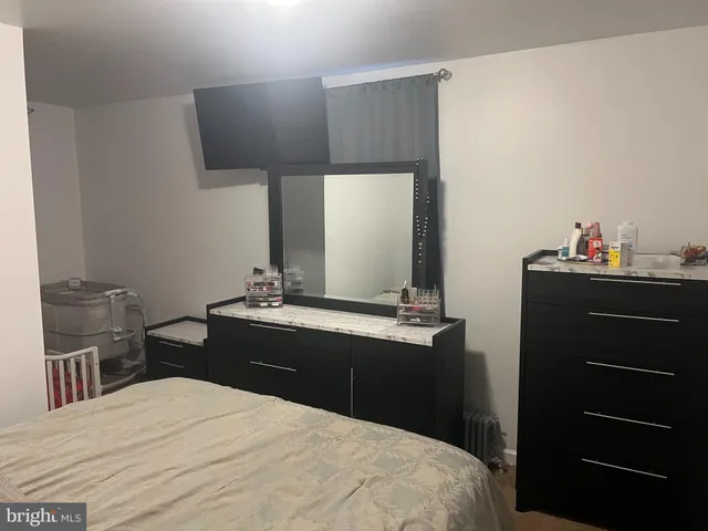a bedroom with a bed and a dresser
