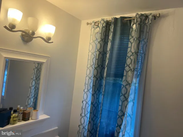 a bathroom with a toilet and a shower curtain