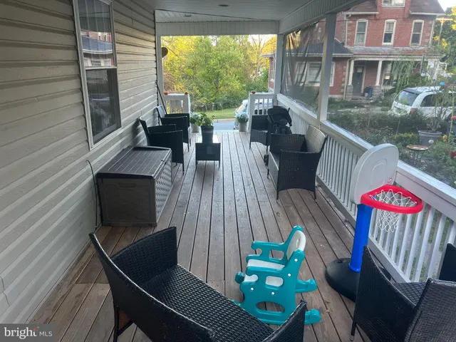 a view of a deck with couches table and chairs with wooden floor