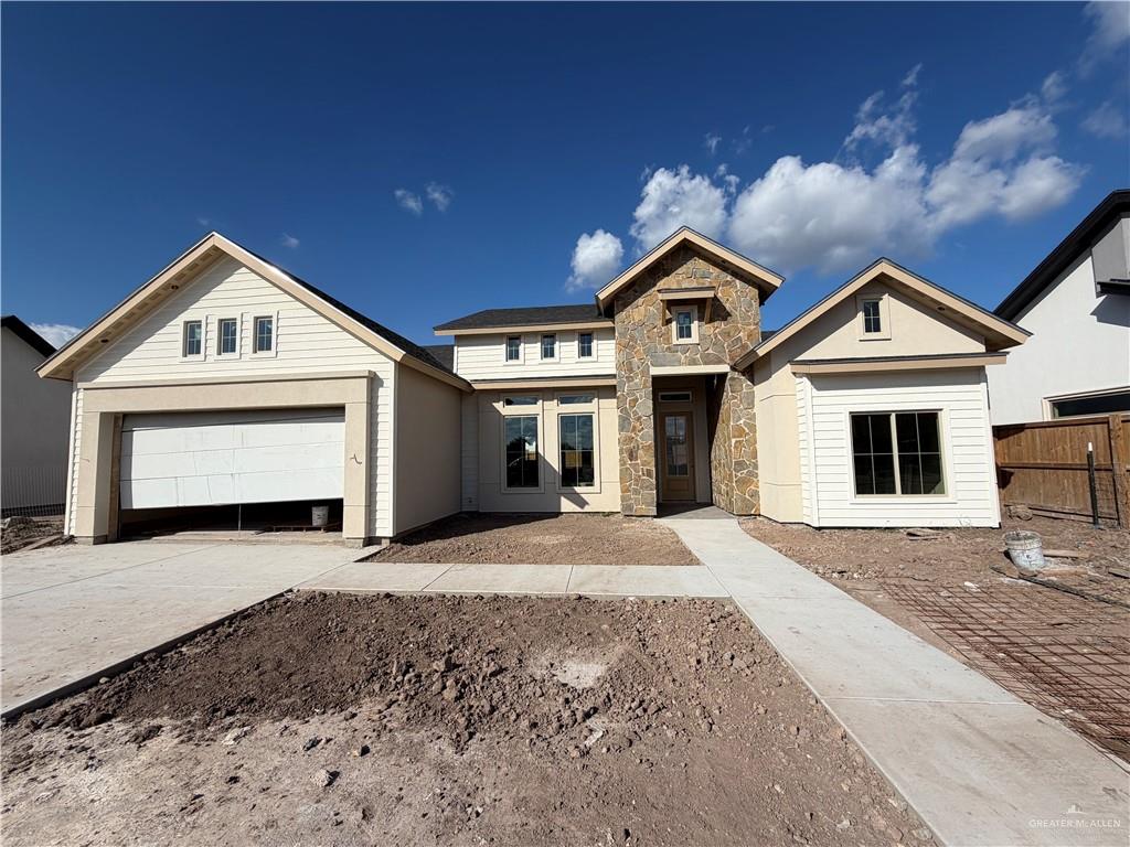 6107 West Street Edcouch, TX 78538 - Photo 1 of 27 a front view of a house with a yard and garage