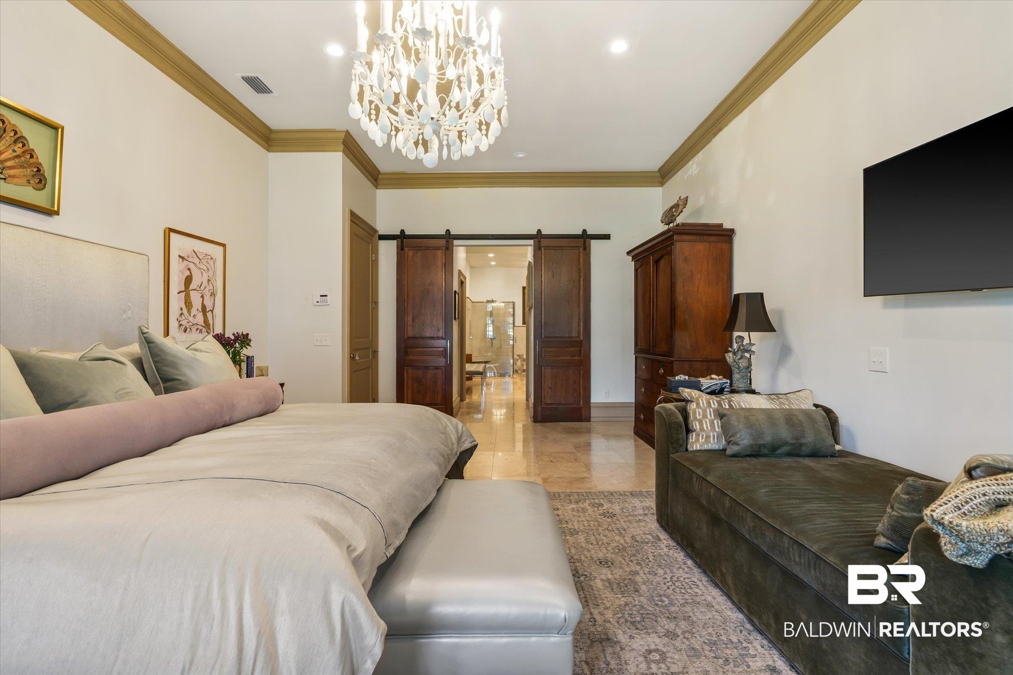 6341 Raintree Road Fairhope, AL 36532 - Photo 15 of 40 Bedroom featuring ornamental molding, light tile patterned floors, an inviting chandelier, and a barn door
