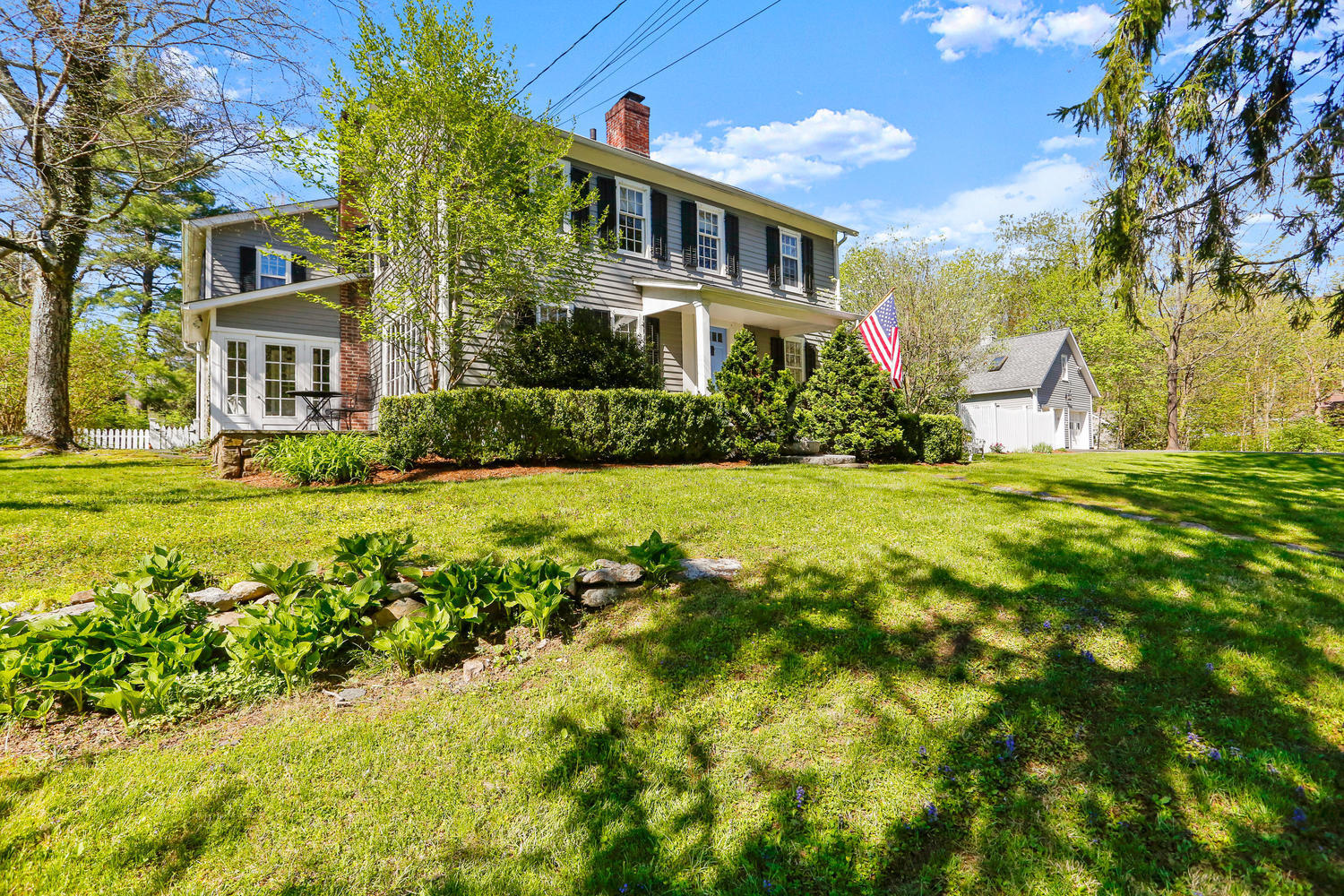 31 Jelliff Mill Road New Canaan, CT 06840 - Photo 1 of 51 a front view of a house with a yard