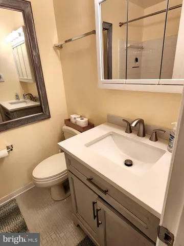 a bathroom with a toilet sink and mirror