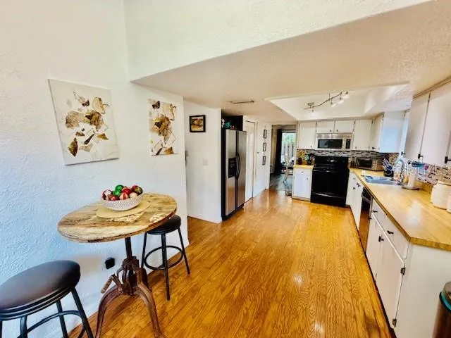 a room with a potted plant and a wooden floor