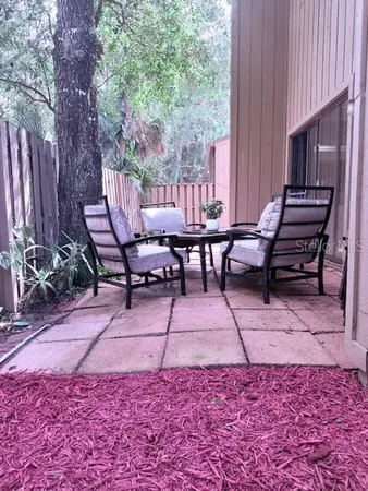 a room with a potted plant and a wooden floor