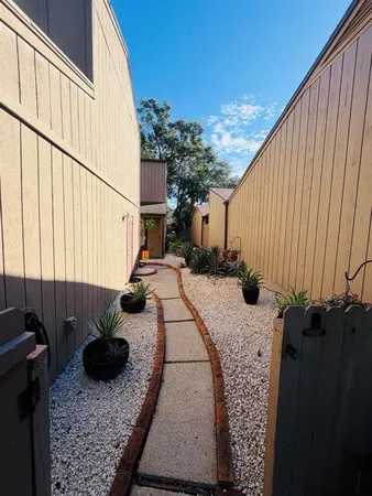 a view of a balcony with flower plants