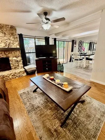 a view of a patio with table and chairs with wooden floor and fence