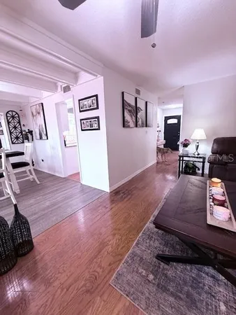 a kitchen with stainless steel appliances kitchen island granite countertop a sink cabinets and wooden floor