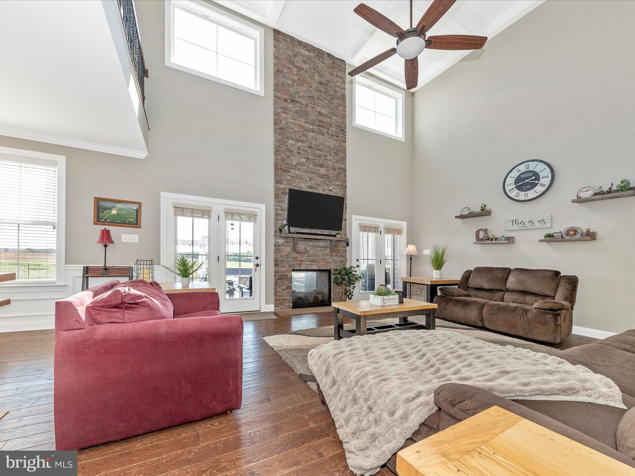 14671 Sugarland Road Poolesville, MD 20837 - Photo 14 of 62 a living room with furniture a fireplace and a large window