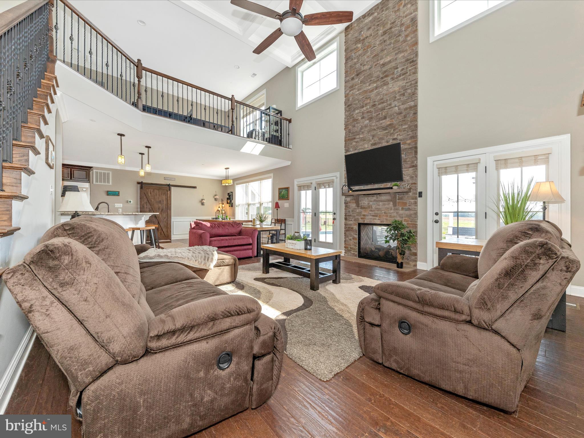14671 Sugarland Road Poolesville, MD 20837 - Photo 15 of 62 a living room with furniture a fireplace and a flat screen tv